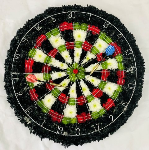 <h2>Dartboard Tribute | Funeral Flowers</h2>
<ul>
<li>Hand created Dartboard complete with real darts</li>
<li>To give you the best we may occasionally need to make substitutes</li>
<li>Funeral Flowers will be delivered at least 2 hours before the funeral</li>
<li>For delivery area coverage see below</li>
</ul>
<br>
<h2>Liverpool Flower Delivery</h2>
<p>We have a wide selection of Bespoke Funeral Tributes offered for Liverpool Flower Delivery. Bespoke Funeral Tributes can be provided for you in Liverpool, Merseyside and we can organize Funeral flower deliveries for you nationwide. Funeral Flowers can be delivered to the Funeral directors or a house address. They can not be delivered to the crematorium or the church.</p>
<br>
<h2>Flower Delivery Coverage</h2>
<p>Our shop delivers funeral flowers to the following Liverpool postcodes L1 L2 L3 L4 L5 L6 L7 L8 L11 L12 L13 L14 L15 L16 L17 L18 L19 L24 L25 L26 L27 L36 L70 If your order is for an area outside of these we can organise delivery for you through our network of florists. We will ask them to make as close as possible to the image but because of the difference in stock and sundry items it may not be exact.</p>
<br>
<h2>Liverpool Funeral Flowers | Bespoke Tributes</h2>
<p>A mass of double spray chrysanthemums are used in this dartboard tribute, sprayed red, green and black to create the distinctive pattern. Finished with silver numbers and actual darts.  This bespoke funeral tribute has been loving handcrafted by our expert florists and is an ideal funeral tribute for a dart player.</p>
<br>
<p>Bespoke Funeral Tributes are a way to create a tribute that is truly unique and specially designed for a loved one.</p>
<br>
<p>These are sometimes selected by family members as the main tribute or more often a group of friends or workplace colleagues as a symbol of things they associate with the deceased.</p>
<br>
<p>The flowers are arranged in floral foam, which means the flowers have a water source so they look their very best for the day.</p>
<br>
<h2>Best Florist in Liverpool</h2>
<p>Trust Award-winning Liverpool Florist, Booker Flowers and Gifts, to deliver funeral flowers fitting for the occasion delivered in Liverpool, Merseyside and beyond. Our funeral flowers are handcrafted by our team of professional fully qualified who not only lovingly hand make our designs but hand-deliver them, ensuring all our customers are delighted with their flowers. Booker Flowers and Gifts your local Liverpool Flower shop.</p>
<br>
<p><em>Debera G - 5 Star Review on yell.com - Funeral Florist Liverpool</em></p>
<br>
<p><em>Fleur and her team made the flowers for my Dad's funeral. I knew I wanted something quite specific but was quite unsure how to execute the idea. Fleur understood immediately what I was hoping to achieve and developed the ideas into amazingly beautiful flowers that were just perfect. I honestly can't recommend her highly enough - she created something outstanding and unique for my Dad. Thanks Fleur.</em></p>